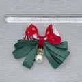 Red and green Christmas ribbon bow with white pearl charm and rhinestone ring detail - Red Polka Dot Wave Pattern