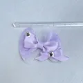 Detail of purple satin and glitter mesh bows with rhinestones next to a scale ruler - Mesh Rhinestone Design (10)