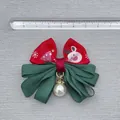 Detail of a Christmas bow with reindeer print, green ribbons and a pearl pendant - Red Ribbon Reindeer Tree Pattern