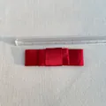 Detail of a red satin multi-layer bow accessory with an 8cm scale measurement - Burgundy