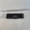 Top view of a 9.5cm black satin bow accessory measured with a ruler on a textured surface - Black
