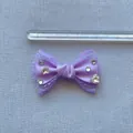 Dettaglio di un fiocco in seta viola da 6 cm fatto a mano con pizzo e strass lucidi - Viola