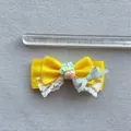 Detail view of a yellow satin bow with white lace and strawberry resin, measuring 8.5 cm - Yellow Style
