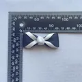 Detail of 4.5cm black and white grosgrain ribbon bow with a ruler for size reference - White/Black