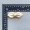 Detail of 50mm cream grosgrain ribbon bow with a tiny crystal star for hair accessories - Off White