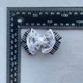 Macro detail of plaid ribbon bow with lace trim and faux pearl for DIY accessories - Black White Grid