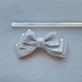 Detail showing grey ribbon bow hair accessory with rhinestones and 9cm measurement scale - Gray