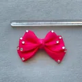 Detail view of 8cm rose pink ribbon bow with rhinestones next to a measuring ruler - Rose Red
