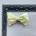 Double-layered light green bow with lace trim and measurement ruler showing dimensions - Pale Green
