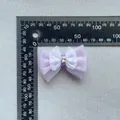 Macro detail of purple mesh bow accessory with sequins and star charm on grey fabric - Purple Sequin Style (6)