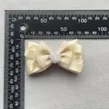 Beige ribbon bow hair accessory with resin rose detail measured by a metal ruler - Textured Double Satin Style (2)