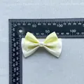 Handmade yellow and white crystal bow accessory with pearl center on gray textured fabric - Pearl Patchwork Satin Lace Bowknot (2)