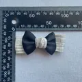 Detailed view showing 60mm handmade fabric bow accessory with a linen texture center - Gray Hemp Texture Style (4)