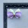 Close-up of floral print bow accessory with strawberry center being measured for size - Purple Strawberry Style (7)