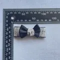 Close-up of handmade tweed fabric hair clip with a black satin bow and 7.5cm scale - Tweed Rectangular Style (7)