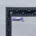 Detail view of a 35mm purple ribbon bow with a white pearl bead for cake decoration - Light Purple (5)