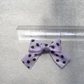 Detail shot of a 3cm light purple polka dot ribbon bow with a transparent ruler - Light Purple