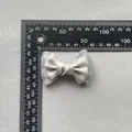 Detailed view of a 6cm double-layer grey satin and mesh bow with delicate beads - Gray