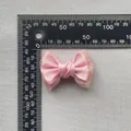 Close-up of pink satin bow with lace backing and rhinestones showing 6cm scale detail - Pink