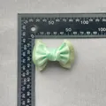 Light green double-layered bow accessory with rhinestones shown against a measuring scale - Mint Green