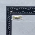 Close-up of a 4cm off-white satin bow with center pearl for cake and fashion decor - Off White (15)