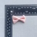 Close-up of pink satin bow hair accessory showing dimensions on a ruler - Classic Simple Ribbon Style (6)