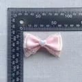 Handmade pink lace ribbon bow accessory with heart bead shown with ruler for size - Lace Trim Heart Gem Style (3)