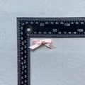 Detailed macro view of a pink satin bow with a central pearl pearl for cake decoration - Dusty Rose (12)