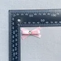 Close-up of a 45mm pink satin DIY bow with a heart-shaped iridescent rhinestone center - Heart Iridescent Rhinestone Style (7)