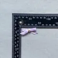 Macro detail of a 30mm light purple satin bow with pearl for cake topper and crafts - Violet (17)