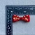 Macro view of a 50mm handmade red satin bow with golden Chinese cloud patterns and ruler scale - Red Gold Cloud Bow Tie Style