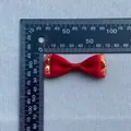 Detail of red satin bow with gold cloud patterns showing 85mm measurement on ruler - Wide Red Gold Cloud Style