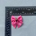 Macro detail of a pink grosgrain bow accessory with rhinestone center measuring 40mm wide - Pink (Pink Rhinestone)