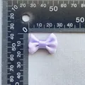Macro detail of 3cm lavender satin bow ornament measured on a black metal scale - Lavender (18)