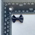 Close-up of a 3cm black satin bow accessory showing fine fabric texture and measurements - Black (6)