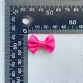 Macro shot of a 3cm hot pink satin bow with a ruler for DIY craft size reference - Rose Red (8)
