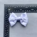 Close-up of white satin bow showing 80mm width measurement for DIY apparel decoration - White