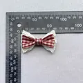 Detail of red gingham bow with white lace trim showing size measurements via ruler - Red White Gingham With Small Wave Lace