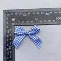 Close-up of blue gingham ribbon bow with 45mm width for DIY garment and hair accessory - Dark Blue White Gingham Ribbon