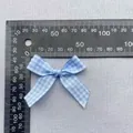 Detailed measurement of blue plaid ribbon bow accessory showing 45mm width on a ruler - Light Blue White Gingham Ribbon