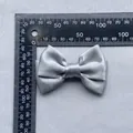 Detail view of silver grey satin double bow accessory with measurement scale reference - Silver Gray