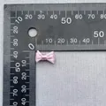 Vista macro de mini lazo de satén rosa de 18mm para ropa de muñecas y manualidades - Rosa Claro
