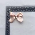 Detailed top view of a 7.5cm champagne satin ribbon bow accessory for garment decor - Champagne (8)