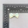 Detail view of a 3.5cm handmade polka dot bow with ruler showing exact dimensions - Green Beige Patchwork Polka Dot (16)