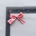 Close-up of a pink satin ribbon bow accessory with ruler for 7.5cm size reference - Pink (9)