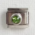 Macro detail of Italian charm link in silver stainless steel with faceted green gemstone - Green