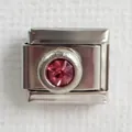 Macro detail of Italian charm link in stainless steel with a round pink birthstone crystal - Rose Red