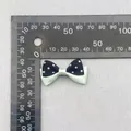 Detail shot of a 3.5cm double-layer polka dot bow with green and black ribbon textures - Green Black Polka Dot Patchwork (59)