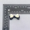 Detailed view of a 33mm double-layered polka dot bow with size scale for DIY accessories - Beige Black Patchwork Bow (77)
