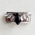 Detailed macro of a gothic bat charm with black enamel and silver textured metal finish - Silver Base Black Bat